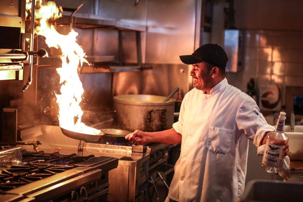 man in white chef uniform cooking - temperature affects food in cooking